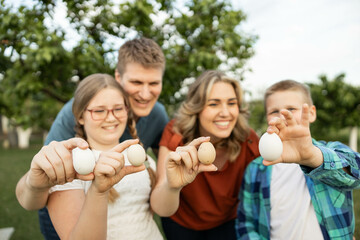 A cheerful family holding fresh eggs in a peaceful garden, capturing the essence of childhood joy and farm life.