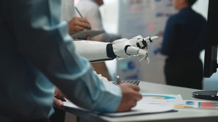 A modern office scene showcasing human and robot collaboration. Professionals engage with technology while presenting data and innovative ideas in a professional environment.Noogenesis