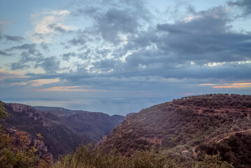 Fototapeta premium Tseria, Kardamyli, Messenia, Mani, Greece: Cloudy sky over mountains and sea horizon