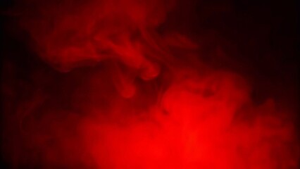 Naklejka premium Red smoke billows against a stark black background, creating a dramatic and striking visual contrast.
