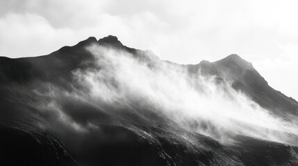 A dramatic monochrome view of a misty mountain ridge landscape