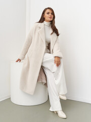 Elegant woman models contemporary fashion in a stylish studio setting