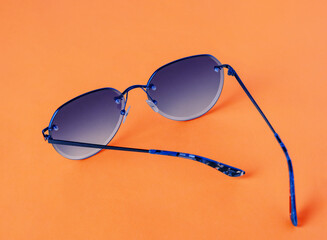 glasses with purple lenses on orange background