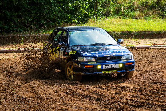 Vranov, Czech Republic - September 21, 2024: Subaru Impreza racing car drives fast in mud off-road. Japanese all-wheel drive car while driving fast.