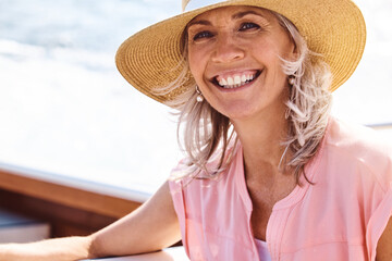 Travel, freedom and portrait for woman on boat for sailing, adventure or summer vacation. Smile, retirement and relaxing with mature tourist and happy on deck of yacht for tropical, cruise or holiday