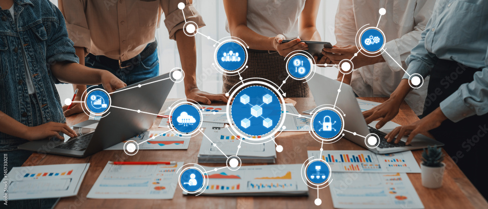 Leinwandbilder A diverse team collaborates in a modern office setting, utilizing technology and digital tools to analyze data and performance metrics displayed on laptops and reports. Amity