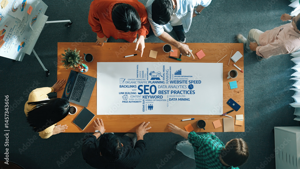 Poster a diverse team collaborates in a modern office environment, discussing seo strategies with a focus o