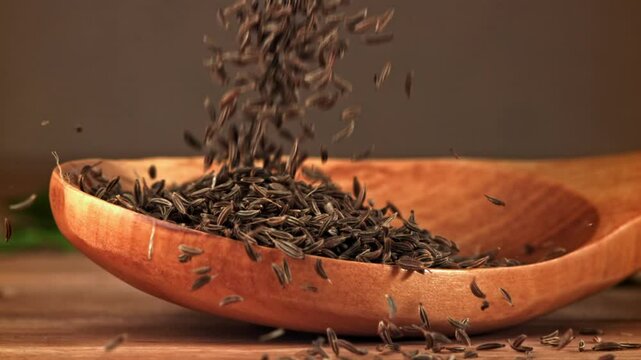 Cumin falls on a wooden spoon. Filmed on a high-speed camera at 1000 fps. High quality FullHD footage