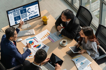 Human resources management software on computer screen helping human resources employee to manage...