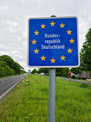 Road sign indicating the border of a country in the European Union: Germany. Written in German - Federal Republic of Germany. Concept of changing the rules for crossing borders in the EU. Vertical.