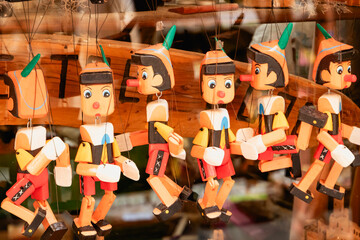 Showcase with charming wooden Pinocchio puppets for puppet theater