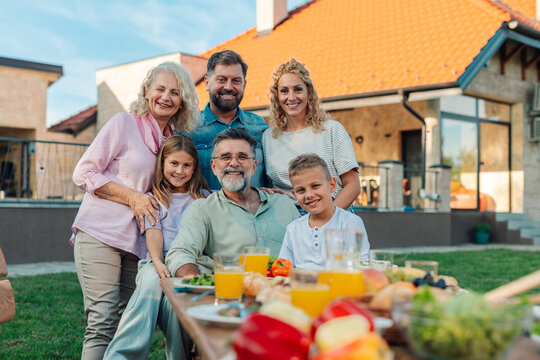 Happy family enjoying backyard meal together at home