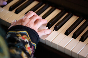 Person Playing Piano Keyboard Indoors Close-Up
