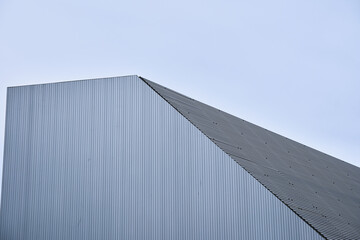 Modern architectural design of angular metal building against clear sky