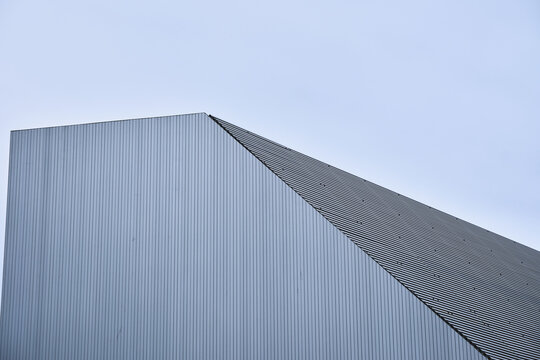 Modern architectural design of angular metal building against clear sky