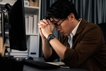 Smart businessman with stressful face working on pc waiting email from customer with making upper...