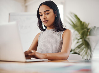 Obraz premium Business woman, typing and laptop in modern office for research, writing email and planning schedule. Journalist, female person and computer for online news app, content creation and editing article