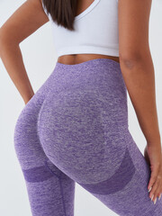 Female model in stylish activewear poses elegantly, showcasing vibrant fashion