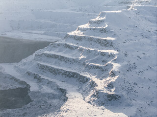 Snow-covered open pit coal mine in winter landscape © Parilov