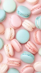 Obraz premium Colorful macarons lie on pink backdrop. Sweet dessert. Food background. Vegetarian snack