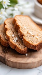 Slices of Sweet Bread sit atop Wood Tray, next to Delicate White Flowers. Sweet Treat, Vegetarian Dessert, Soft Slices