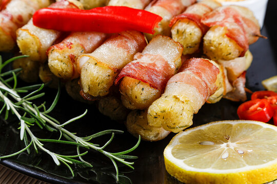 Cassava skewers wrapped in bacon, cassava medallion.