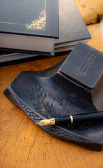 Fountain pen, a beautiful fountain pen with books and other objects on a rustic wooden surface,...