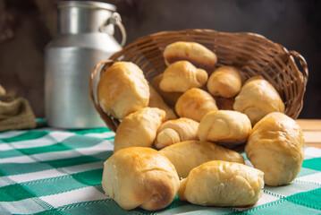 Homemade bread, a beautiful breakfast table with delicious homemade bread on a rustic wooden surface with a tablecloth, selective focus.