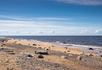 The rocky shore of the Gulf of Riga in the Baltic Sea in Latvia on a sunny May day.