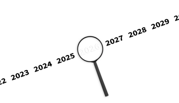 Lens, magnifying glass focusing on the year 2026 on an isolated background. Financial or stock market strategies and past and future events. Close-up
