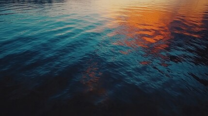 Stunning ocean water surface with sunset reflection orange hues dark blue water texture background