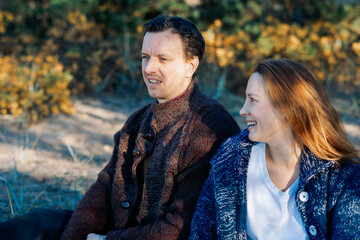 Portrait happy beautiful couple in love enjoying autumn picnic in autumn park. High quality photo