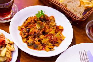Turkish food saksuka with eggplant with tomatoes and olive oil.