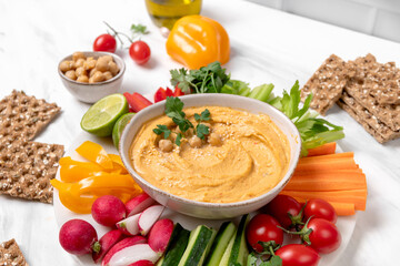 Homemade hummus with vegetables sticks  and multigrain crackers. vegan food healthy eating
