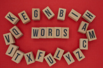 The word WORDS surrounded by scattered letter blocks on red background