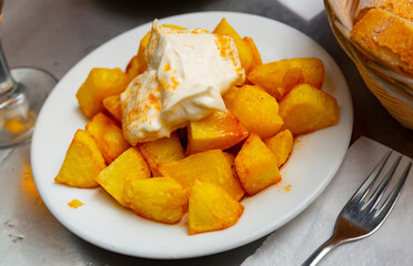 Typical Spanish potato dish Patatas bravas served with spicy sauce