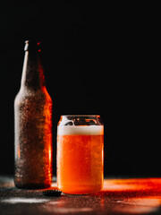 Glass of ice cold beer on black background. Copy space