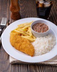 Milanese chicken breast, rice, beans and french fries