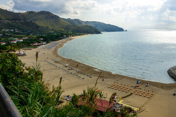 view from above on the Mediterranean Sea and the beach of the city of Sperlonga in Italy. Scenic resort town village with nice sand beach and clear blue water. Famous tourist destination