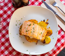 Baked salmon fillet with potatoes and onions. High quality photo