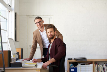 Creative, portrait and men on computer in office for research, planning and ideas as web designer...