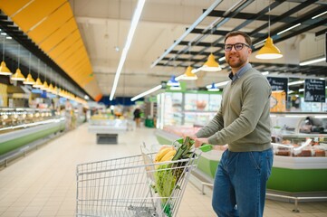 Handsome man shopping in a supermarket