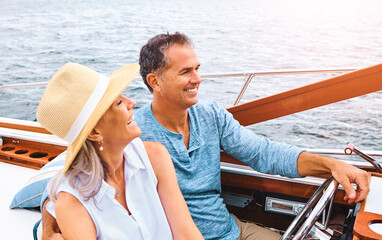 Happy couple, lake adventure and together in boat on holiday, relax on cruise date for retirement...