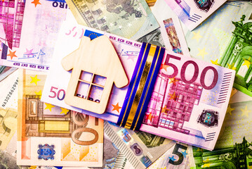Symbol of home and family against the background of the Euro currency
