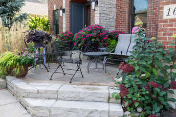Beautiful Little Lime hydrangea bushes and Karl Foerster feather reed  grasses in full bloom late summer lend a romantic feel and curb appeal to the front entrance of this suburban residence. 