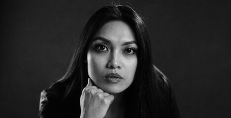 Woman contemplating deeply in a black and white portrait