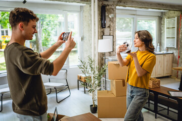 A man is film a woman hold cctv security camera and give instructions