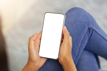 Closeup view of millennial black lady using smartphone with empty screen to work or study online from home, mockup for mobile app design. Remote education or communication concept