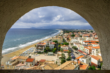 view of the beach and old town of Sperlonga in Italy. Scenic resort town village with nice sand beach and clear blue water. Famous tourist destination