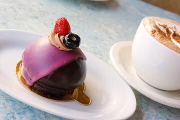 Raspberry mousse coated in chocolate and raspberry fondant